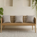 Wooden bench with gray cushions in a room with a light-colored wall and patterned rug.