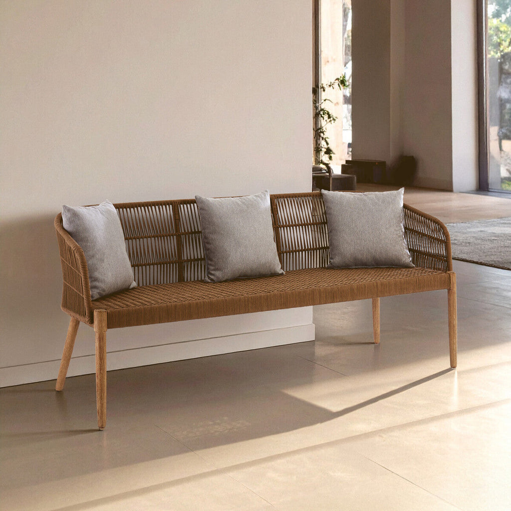 Wicker bench with gray cushions in a modern indoor setting