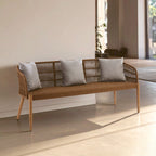 Wicker bench with gray cushions in a modern indoor setting