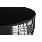 Black round table with textured metal base on a white background