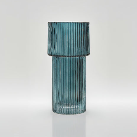 Teal ribbed glass vase on a white background