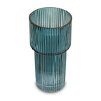 Teal glass vase with ribbed design on a white background