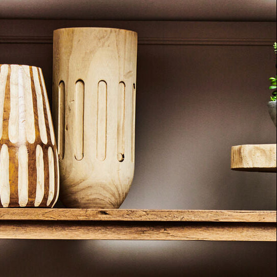 Wooden lampshades on a wooden shelf with a neutral background