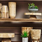 Wooden vases and planters on a shelf against a neutral background