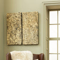 Abstract wall art with concentric circles on a beige wall next to a window.