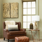 Brown leather armchair with ottoman in a living room setting