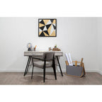 Modern office desk with chair, decorative items, and a wall art piece.