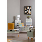 Modern furniture set with side tables and a cabinet in a room with a geometric wall art.