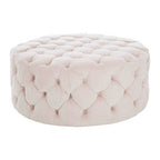 Pink tufted ottoman on a white background