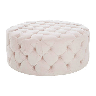 Pink tufted ottoman on a white background