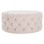 Pink tufted ottoman on a white background