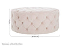 Pink tufted ottoman with dimensions on a white background