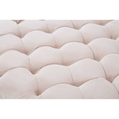 Close-up of a tufted pink cushion on a white background