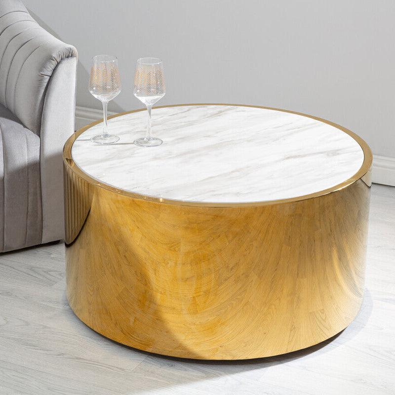 Round wooden coffee table with marble top in a living room setting