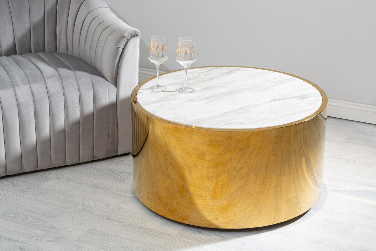Round wooden coffee table with marble top in a living room setting