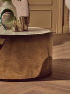 Wooden side table with decorative items on a wooden floor