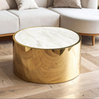 Round gold coffee table with marble top in a living room setting