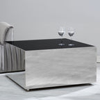 Modern coffee table with a black top and gray base in a minimalistic room.