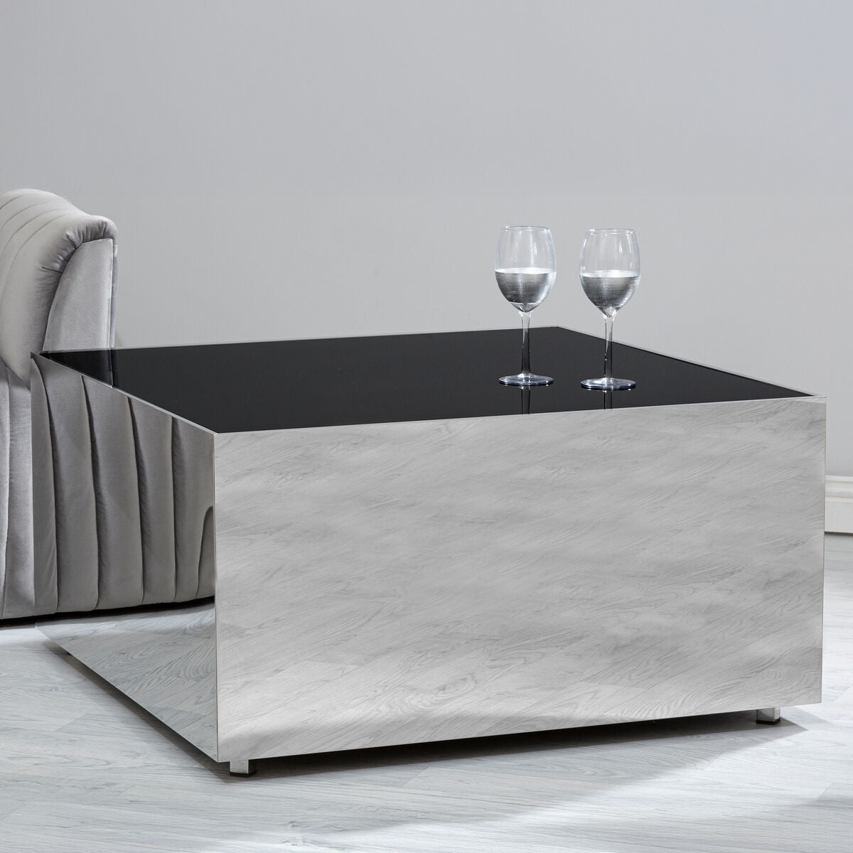 Modern coffee table with a black top and gray base in a minimalistic room.