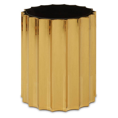 Gold metallic side table with a black top on a white background
