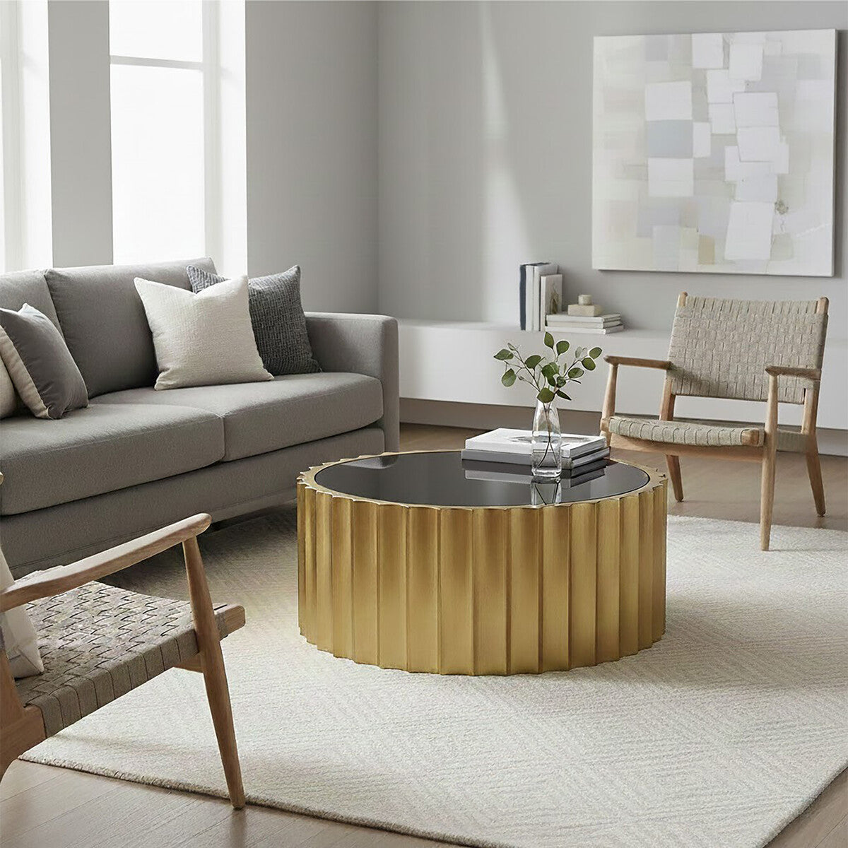 Modern living room with a gold coffee table, gray sofa, and wooden armchair.