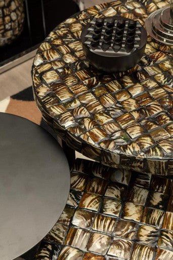 Round table with mosaic tile design in a room setting