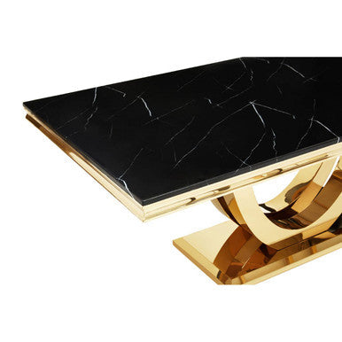Coffee table with black marble top and gold base on a white background