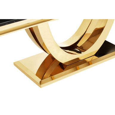 Gold decorative object with interlocking rings on a white background