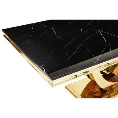 Decorative table with black marble top and gold base on a white background