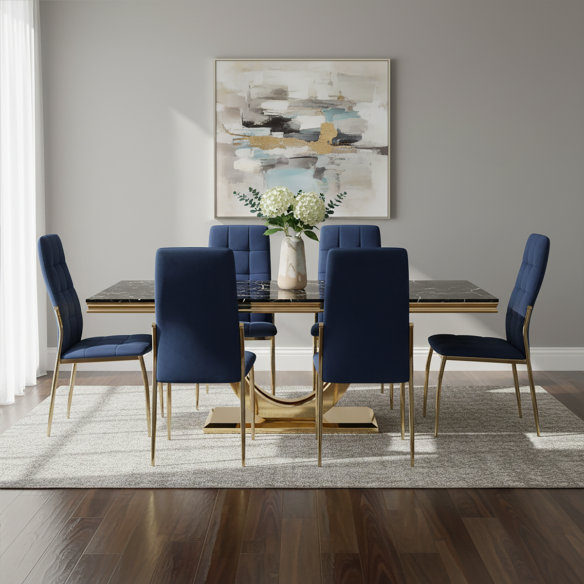 Dining room with a gold table and blue chairs, featuring a abstract painting on the wall.
