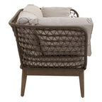 Wicker chair with woven backrest and beige cushions on a white background