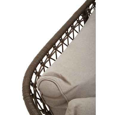 Close-up of a wicker chair with a beige cushion on a white background