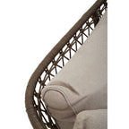 Close-up of a wicker chair with a beige cushion on a white background