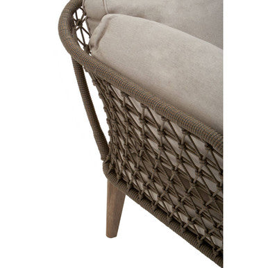 Woven chair with beige cushion on a white background