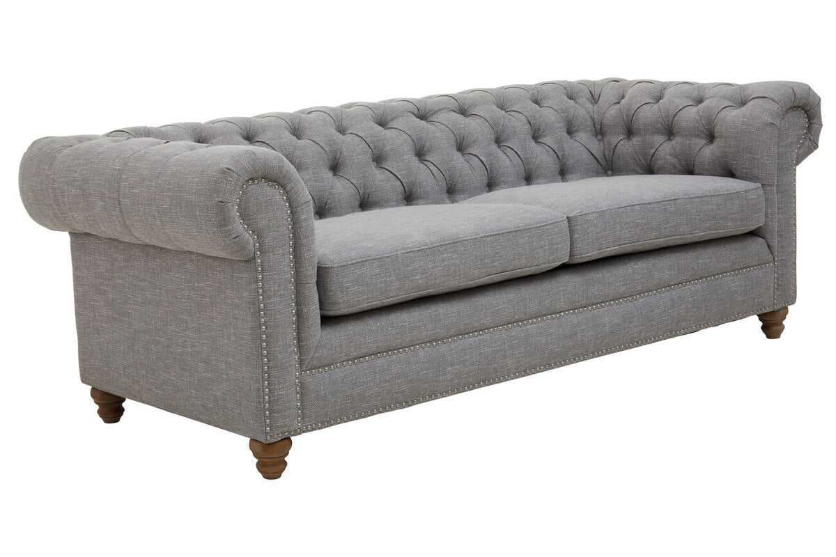 Gray tufted sofa on a white background