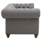 Gray tufted armchair with wooden legs on a white background