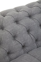 Close-up of a tufted gray fabric sofa