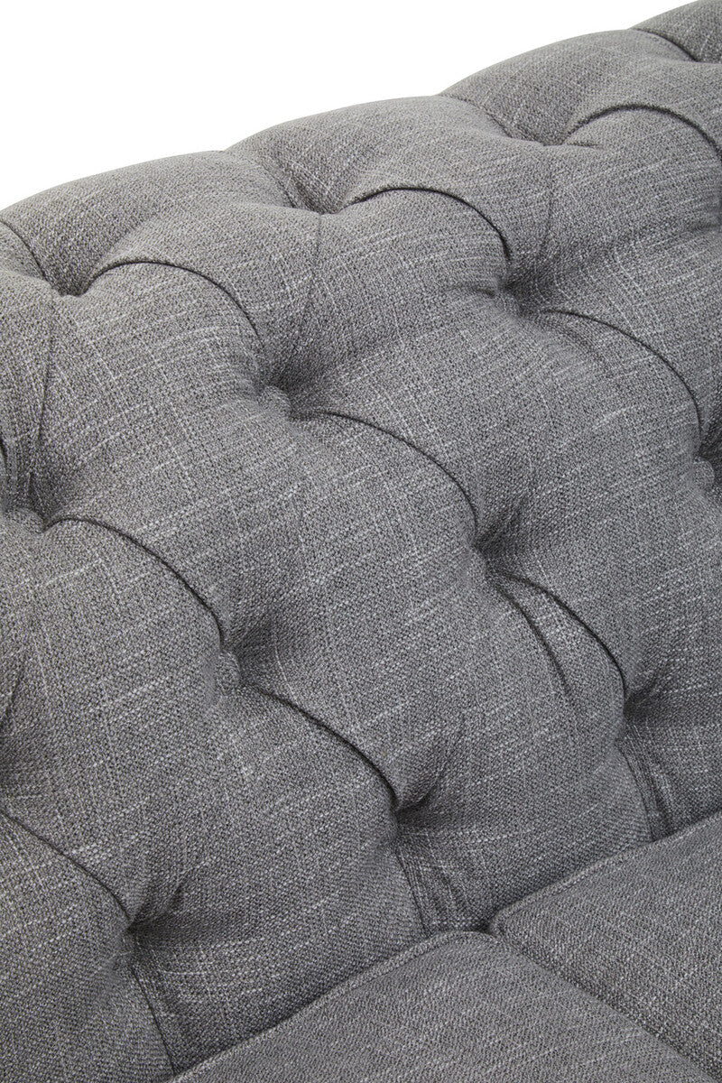 Close-up of a tufted gray fabric sofa