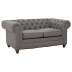 Gray tufted sofa on a white background