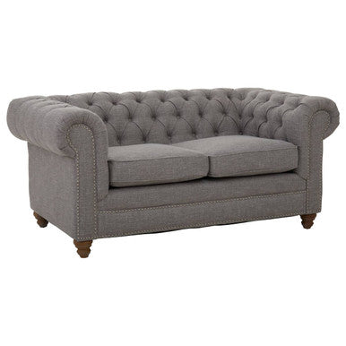 Gray tufted sofa on a white background