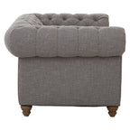Gray tufted armchair on a white background