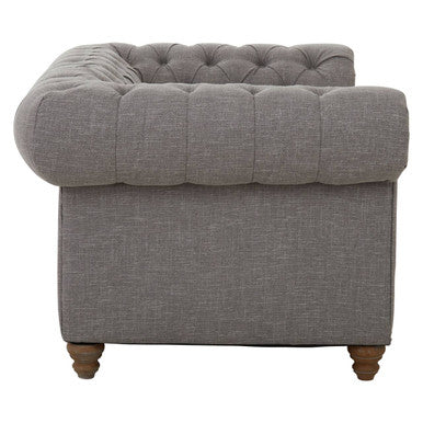 Gray tufted armchair on a white background