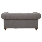 Gray sofa with tufted backrest on a white background