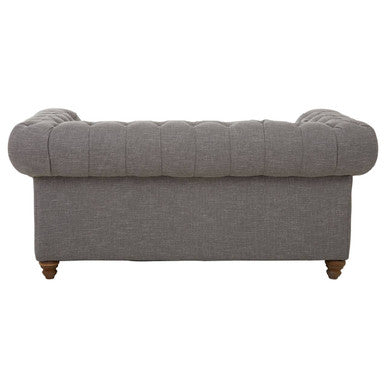 Gray sofa with tufted backrest on a white background