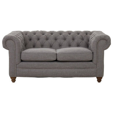 Gray tufted sofa on a white background