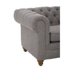 Gray tufted armchair with wooden legs on a white background