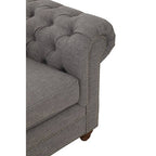 Gray tufted sofa corner on a white background