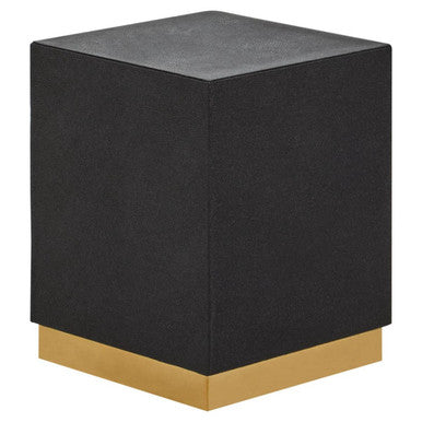 Black cube-shaped stool with a gold base on a white background