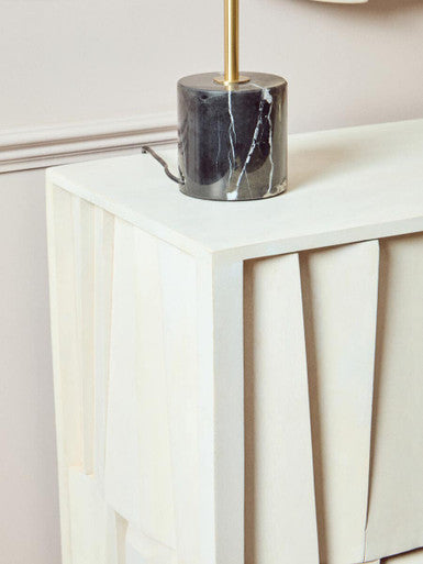 Decorative lamp with marble base on a white surface