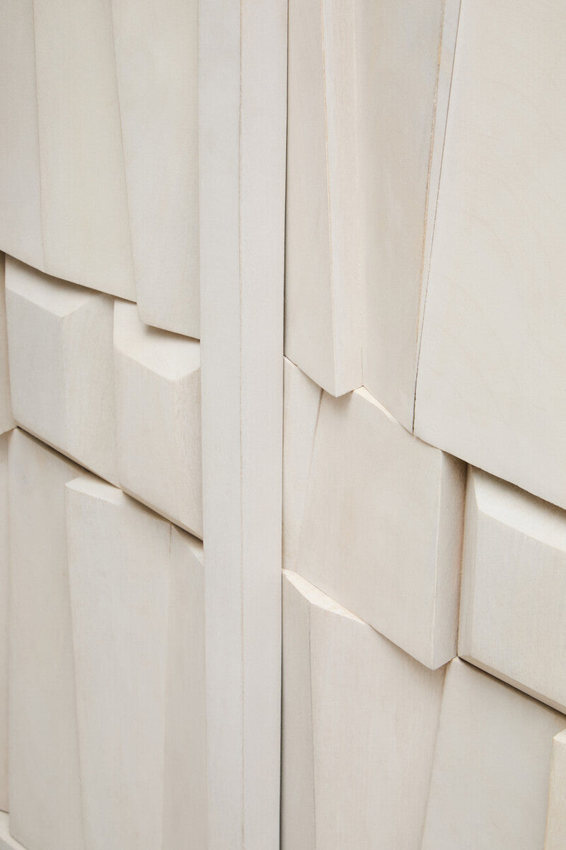 Close-up of a textured white wall with geometric patterns